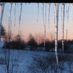 icicles hanging from porch at sunset