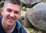 Matt Long of Landlopers with tortoise in Galapagos