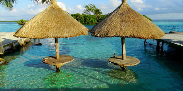 palapas in sea at The Split - Caye Caulker