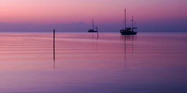 Calm Belize sunset over sea in lavender