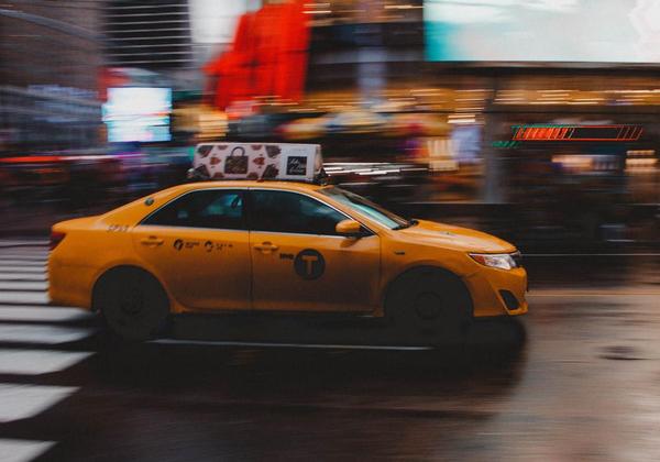 Taxi racing through city streets-small